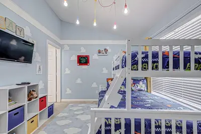 a childs bedroom with a bunk bed and a tv at SilverPalm Disney Home, Free Amenities, 3mi Disney in Kissimmee