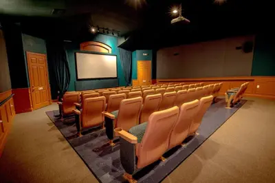 an empty lecture hall with chairs and a screen at SilverPalm Disney Home, Free Amenities, 3mi Disney in Kissimmee