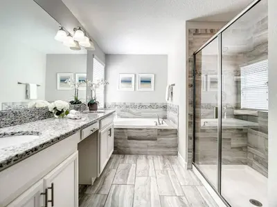 a bathroom with a shower and a sink and a tub at StoreyLake Imagination Villa, 5mi Disney Universal in Kissimmee