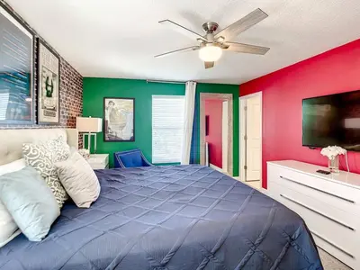 a bedroom with a blue bed with a ceiling fan at StoreyLake Imagination Villa, 5mi Disney Universal in Kissimmee