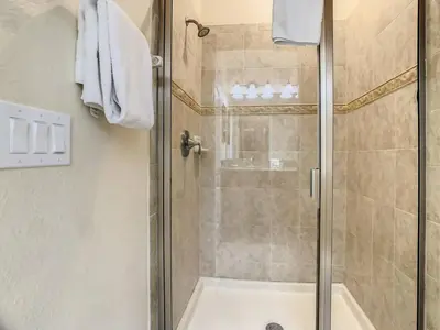 a bathroom with a shower with a glass door at Storey Lake Dreamy Townhome, 5 mi Disney Universal in Kissimmee