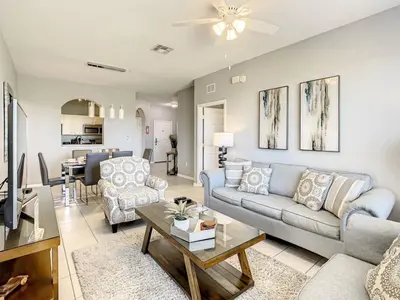 a living room with a couch and a table at Windsor Hills Themed Condo, 2.5mi to Disney in Orlando