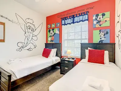 two beds in a room with red walls at Windsor Hills Themed Condo, 2.5mi to Disney in Orlando