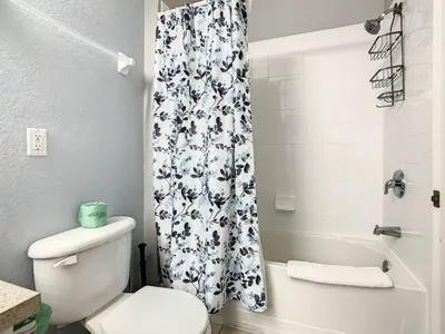 a bathroom with a toilet and a shower curtain at Windsor Hills Themed Condo, 2.5mi to Disney in Orlando