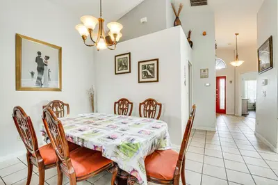 a dining room with a table and chairs at 4 Mi to Disney Spacious Retreat with Pool and Yard! in Kissimmee