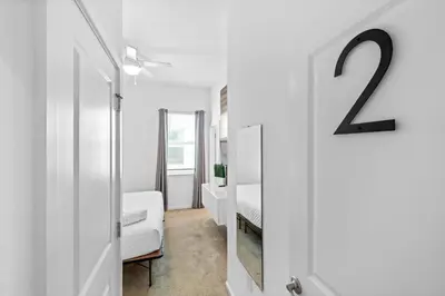 a white room with a bed and a mirror at Big Family Home with Game Room Sleeps 28 BLV104 in Kissimmee