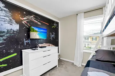 a bedroom with a bed and a tv on a wall at Comfy House at Compass Bay CB102 in Kissimmee