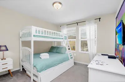 a bedroom with a bunk bed and a desk at Comfy House at Compass Bay CB102 in Kissimmee