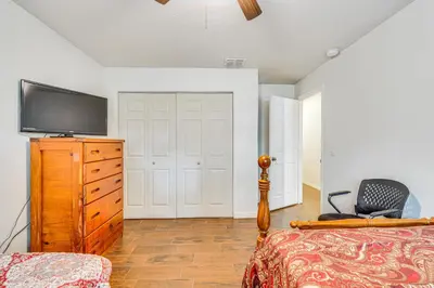 a bedroom with a bed and a television on a dresser at Orlando-Area Family Oasis with Lanai, Pool and Yard in Orlando