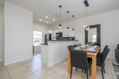 a dining room and kitchen with a table and chairs at Perfect Themed 3 BD Hot tub renovated - 3013 in Kissimmee