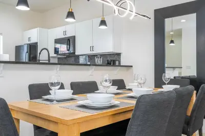 a dining room with a wooden table and chairs at Perfect Themed 3 BD Hot tub renovated - 3013 in Kissimmee