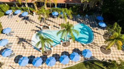 an overhead view of a pool with palm trees and umbrellas at Perfect Themed 3 BD Hot tub renovated - 3013 in Kissimmee