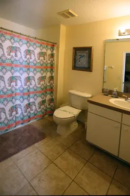 a bathroom with a toilet and a sink at UniDisL 3Br3B near Disney quiet resort community, pool, private hot tub, BBQ & games in Kissimmee