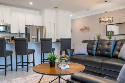 a living room with a couch and a table at 4Bd Close to Disney with Pool at Storey Lake 2560 in Kissimmee