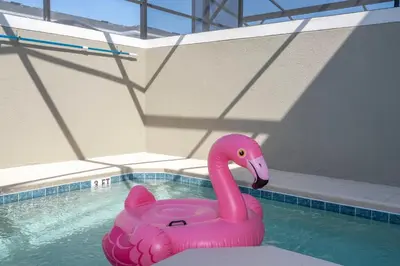 a pink swan float in a swimming pool at 4Bd Close to Disney with Pool at Storey Lake 2560 in Kissimmee