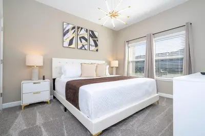 a bedroom with a white bed and a window at 4Bd Close to Disney with Pool at Storey Lake 2560 in Kissimmee