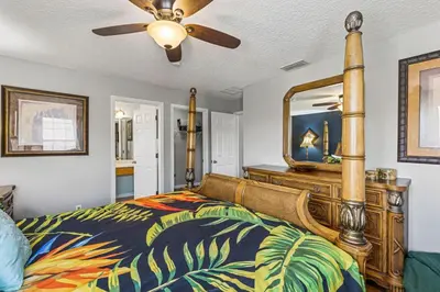 a bedroom with a bed and a mirror at 7BDM Prvt Pool Villa - Gated Resort 10min to Disney in Kissimmee