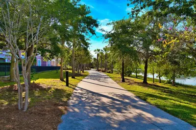 a walkway in a park with trees and grass at The Epic Toronto Vista Cay Orlando in Orlando