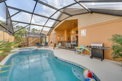 a swimming pool in a house with a large window at Renovated Kissimmee Home - 10 Mi to Disney Springs in Kissimmee