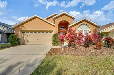 a house with a driveway and a garage at Renovated Kissimmee Home - 10 Mi to Disney Springs in Kissimmee