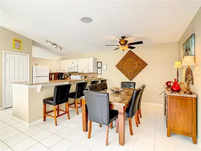 a kitchen and dining room with a table and chairs at Private Pool With Heat - Close to Disney! in Kissimmee