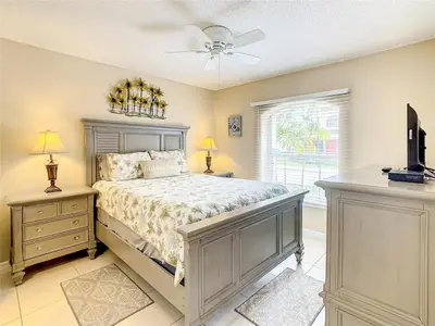 a bedroom with a bed and a ceiling fan at Private Pool With Heat - Close to Disney! in Kissimmee