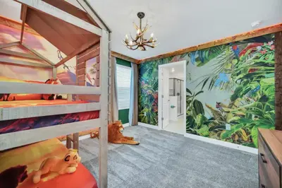 a bedroom with two bunk beds and a mural at Amazing 9 Bedroom Lake View in Kissimmee
