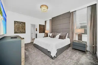 a bedroom with a large white bed and a window at Amazing 9 Bedroom Lake View in Kissimmee