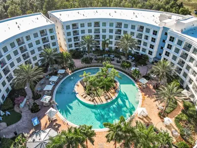 an aerial view of the resort with a pool and palm trees at 1Bed/1Bath Pet Friendly Condo at the Melia in Orlando