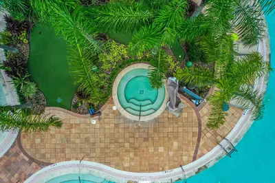 an overhead view of a swimming pool with palm trees at 1Bed/1Bath Pet Friendly Condo at the Melia in Orlando