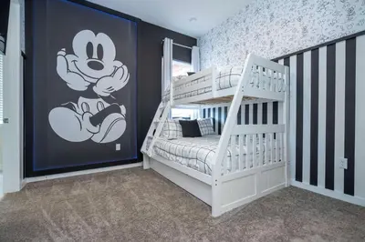 a bedroom with a mickey mouse mural on the wall at Amazing 2024 Villa 5 min to Disney in Orlando