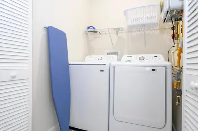 a laundry room with two washer and dryer at Amazing 2024 Villa 5 min to Disney in Orlando