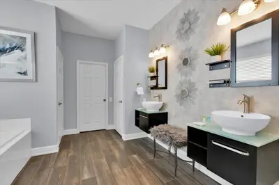 a bathroom with two sinks and a mirror at 8131 Sun Palm in Kissimmee