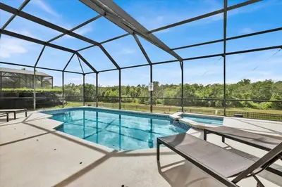 an indoor swimming pool with a large glass ceiling at 8131 Sun Palm in Kissimmee