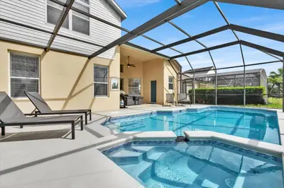 a swimming pool with a pergola on a house at 8131 Sun Palm in Kissimmee