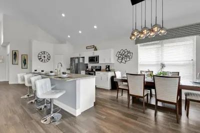 a kitchen and dining room with a table and chairs at 8131 Sun Palm in Kissimmee