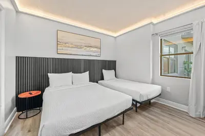 a room with two beds and a window at Exclusive Ground floor Apartment with Balcony in Orlando