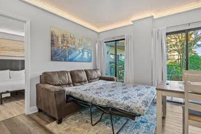 a living room with a couch and a table at Exclusive Ground floor Apartment with Balcony in Orlando