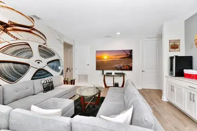 a living room with a couch and a tv at Lavish Home Near Disney With Media, Game & Theme Rooms With Waterpark & Resort Access At Encore Resorts Reunion - 520Bu in Kissimmee