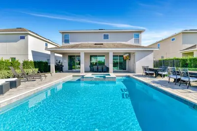 a swimming pool in front of a house at Lavish Home Near Disney With Media, Game & Theme Rooms With Waterpark & Resort Access At Encore Resorts Reunion - 520Bu in Kissimmee