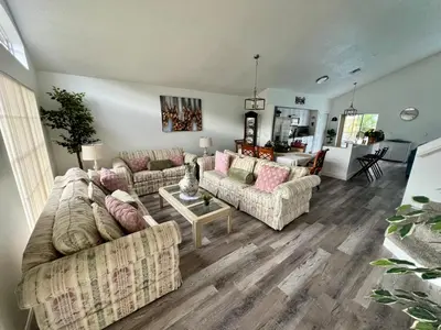 a living room with two couches and a table at Buena Ventura Escape in Kissimmee