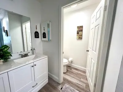 a white bathroom with a sink and a toilet at Buena Ventura Escape in Kissimmee