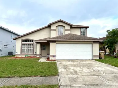 a large house with a white garage at Buena Ventura Escape in Kissimmee