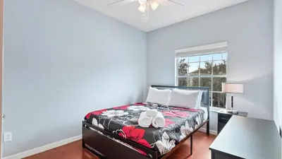 a bedroom with a bed and a desk and a window at Shvck4 - Coral Cay Resort #4 - 4 Bed 3 Baths Townhome in Kissimmee
