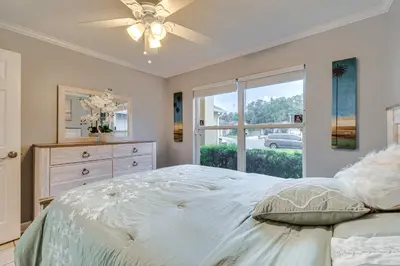 a bedroom with a large bed and a window at Lovely Florida Retreat with Lanai 5 Mi to Riverwalk in Lake Mary