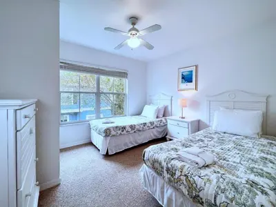 a bedroom with two beds and a ceiling fan at Lovely Family Town home in Great Location townhouse in Kissimmee