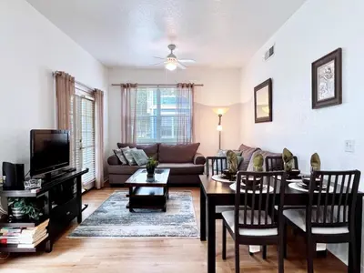 a living room with a table and a couch at Lovely Family Town home in Great Location townhouse in Kissimmee
