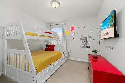 a white bunk bed in a room with a red desk at Charming Challet at Compass Bay CB101 in Kissimmee