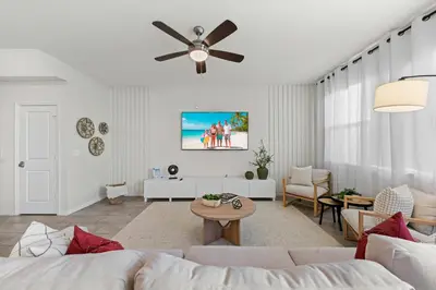 a living room with a couch and a ceiling fan at Charming Challet at Compass Bay CB101 in Kissimmee