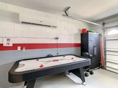 a room with a ping pong table in a room at 2025 Deals Are Here! Book Now Before Rates Go Up! in Kissimmee